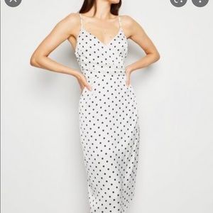 Polka dot silky dress with wrapped bust in black and white. Plus.
